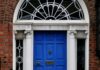 The 21-day habit rule came from a plastic surgeon’s book preface A woman walking past a blue door on a brick building