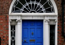 The 21-day habit rule came from a plastic surgeon’s book preface A woman walking past a blue door on a brick building