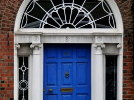 The 21-day habit rule came from a plastic surgeon’s book preface A woman walking past a blue door on a brick building