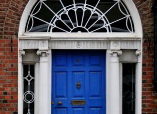 The 21-day habit rule came from a plastic surgeon’s book preface A woman walking past a blue door on a brick building