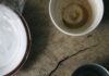 Breakfast is not the most important meal of the day Used breakfast dishes and a crumpled napkin on a wooden table