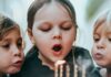 Sugar Does Not Make Children Hyperactive. The Study That Proved It Tested the Parents. Two young children blowing out candles on a birthday cake