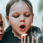 Sugar Does Not Make Children Hyperactive. The Study That Proved It Tested the Parents. Two young children blowing out candles on a birthday cake