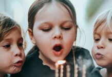 Sugar Does Not Make Children Hyperactive. The Study That Proved It Tested the Parents. Two young children blowing out candles on a birthday cake
