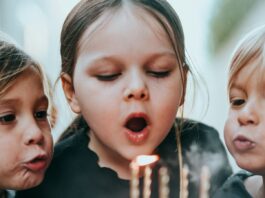 Sugar Does Not Make Children Hyperactive. The Study That Proved It Tested the Parents. Two young children blowing out candles on a birthday cake