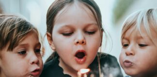 Sugar Does Not Make Children Hyperactive. The Study That Proved It Tested the Parents. Two young children blowing out candles on a birthday cake