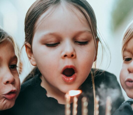 Sugar Does Not Make Children Hyperactive. The Study That Proved It Tested the Parents. Two young children blowing out candles on a birthday cake