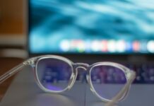 Blue-Light Glasses: What the Cochrane Review Found A pair of silver-framed eyeglasses resting on a white table