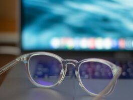 Blue-Light Glasses: What the Cochrane Review Found A pair of silver-framed eyeglasses resting on a white table
