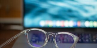 Blue-Light Glasses: What the Cochrane Review Found A pair of silver-framed eyeglasses resting on a white table