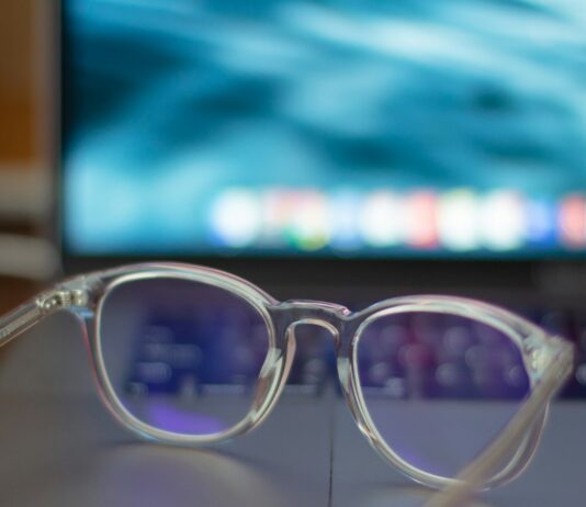 Blue-Light Glasses: What the Cochrane Review Found A pair of silver-framed eyeglasses resting on a white table
