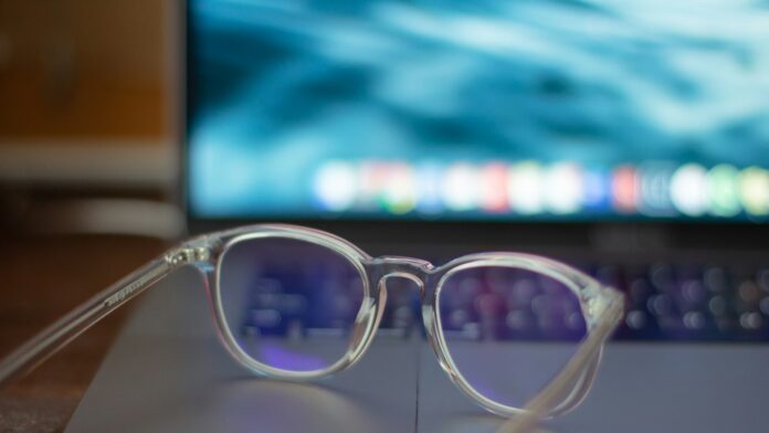 eyeglasses-desk A pair of silver-framed eyeglasses resting on a white table
