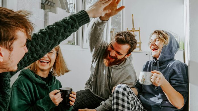 friends-coffee-laughing Four friends laughing together over coffee