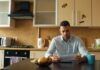 Where the three-to-six-month emergency fund rule actually came from A man reading a document at a kitchen table