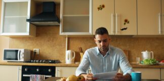 Where the three-to-six-month emergency fund rule actually came from A man reading a document at a kitchen table