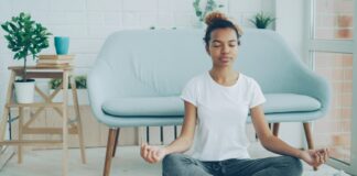 The Meditation Researchers Auditing Their Own Field A young woman sitting cross-legged meditating on the floor at home