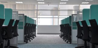 The four-day week trials mostly didn’t test a four-day week Empty office chairs at cubicles