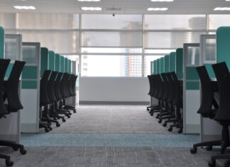 The four-day week trials mostly didn’t test a four-day week Empty office chairs at cubicles