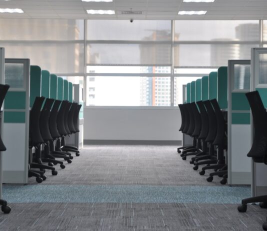 The four-day week trials mostly didn’t test a four-day week Empty office chairs at cubicles