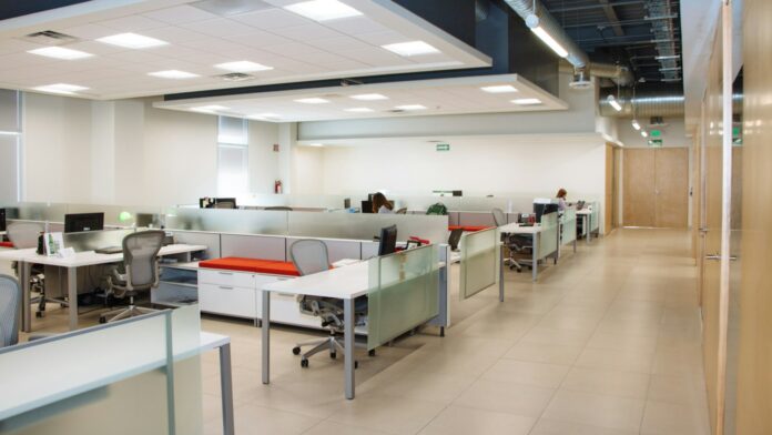 open-plan-office An open plan office with long rows of white desks