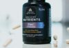 The Vitamin D Trials Nobody Talks About A bottle of vitamin supplements on a plain surface