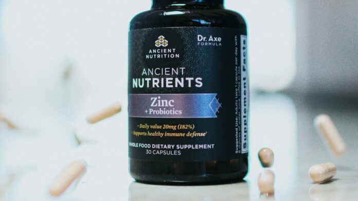 vitamin-d-bottle A bottle of vitamin supplements on a plain surface