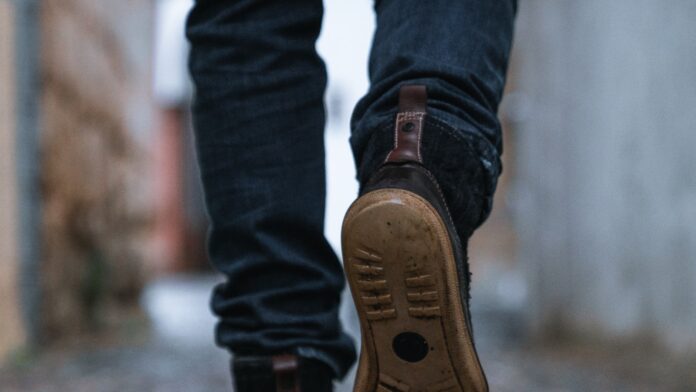 Close-up of a person walking on a pavement