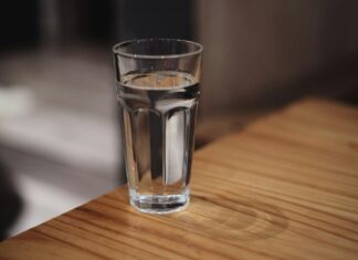 A glass of water on a wooden surface