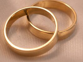 The 50% Divorce Rate Was True for About One Year. You Can Name It. Two interlocking gold wedding bands on a textured surface
